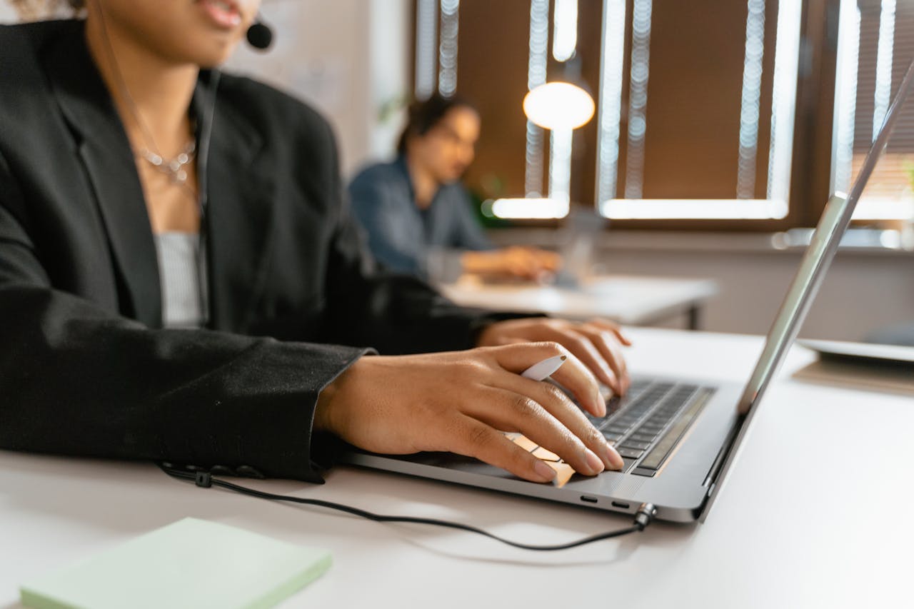 Close-up of a headset resting on a laptop, symbolizing efficient work environment technology.